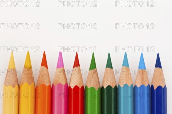 Many different coloured pencils on a white background, Many different colored pencils on white