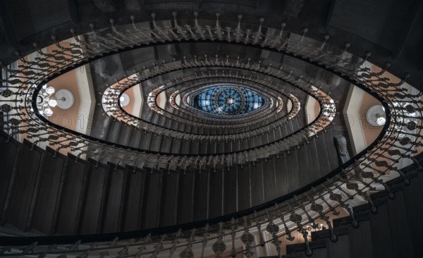 Eye-catching image with staircase design in a spiral form, a pattern of oval figures, illuminated