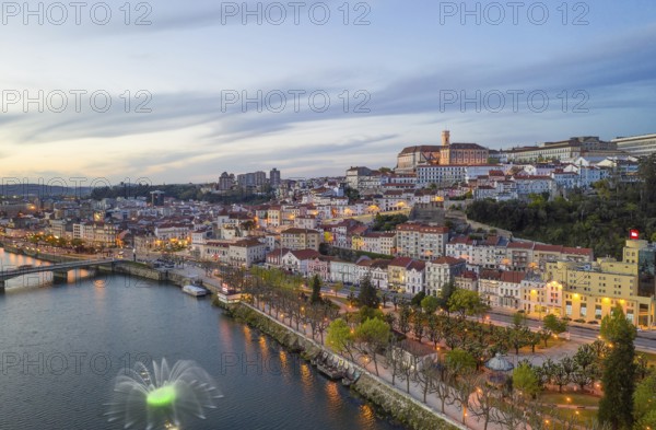 Coimbra drone aerial city view at sunset with colorful fountain in Mondego river and beautiful