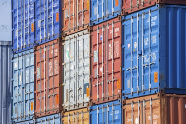 Stacked colourful freight containers at the container terminal in Holz-und Fabrikenhafen, Bremen,