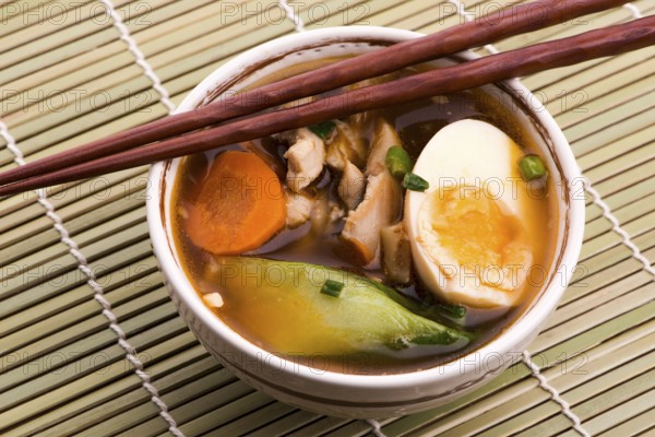 Ramen egg noodle soup dish with salmon fish