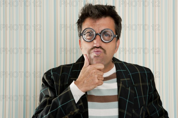 Nerd silly myopic man with glasses thinking doing funny gesture with retro mustache