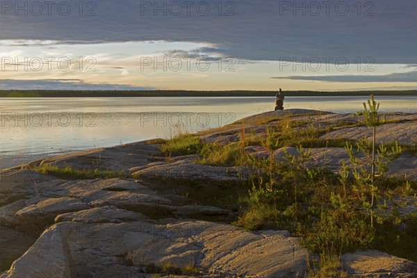 Evening on the White Sea. Stone pillar on coastal granite rock. Kandalaksha Gulf, Karelia, Russia,