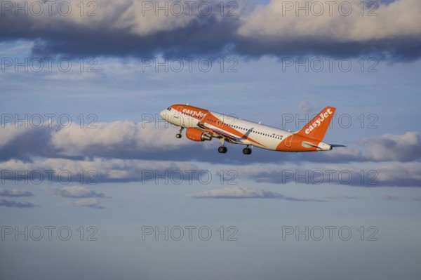 Lisbon, Portugal - Apr 29, 2024: EasyJet Airbus 320 aircraft shot mid-flight, ascending into clear