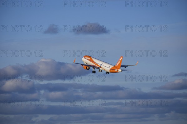 Lisbon, Portugal - Apr 29, 2024: EasyJet Airbus 321 neo aircraft shot mid-flight, ascending into