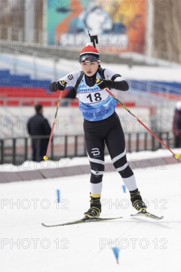 Korean sportswoman biathlete Choi Yoonah skiing on distance biathlon stadium during Open regional