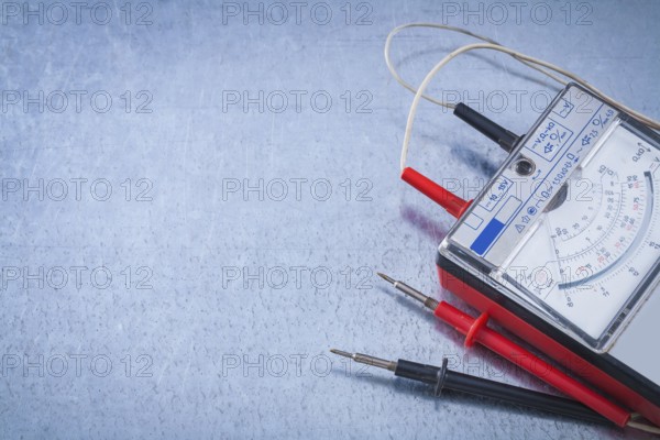 Electrician's instrument of measurement on scratched metallic background construction concept
