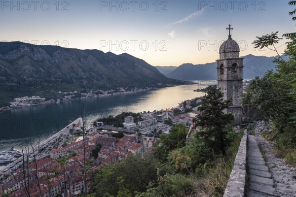 The tower of Church of Our Lady of Remedy and Bay of Kotor view from the hill above the town,