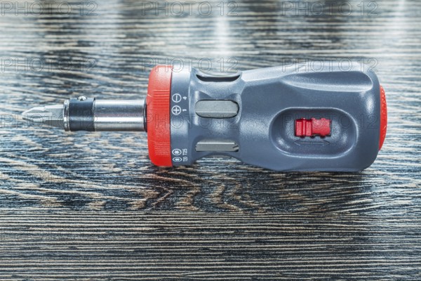 Screwdriver on wooden board top view