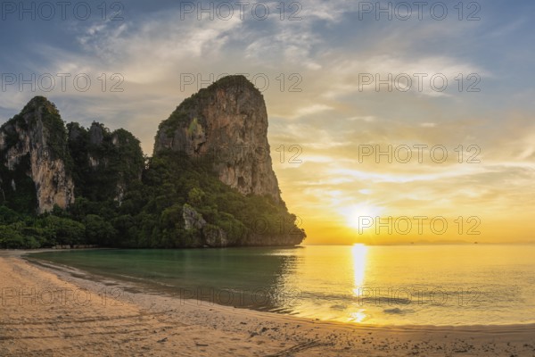 Tropical islands sunset view with ocean sea water and sand beach at Railay Beach, Krabi Thailand