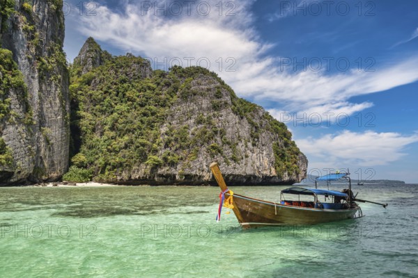 Tropical islands view with long tail boat ocean blue sea water at Pileh Lagoon of Phi Phi Islands,