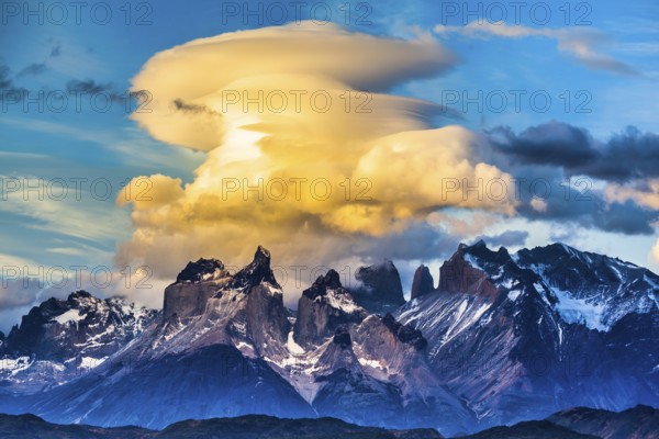 Magnificent cumulus clouds in the rays of the sunset. Torres del Paine National Park. Summer in the