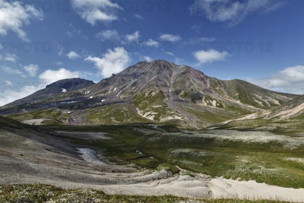 Summer mountain landscape of Kamchatka Peninsula: beautiful view of cone Khangar Volcano on sunny