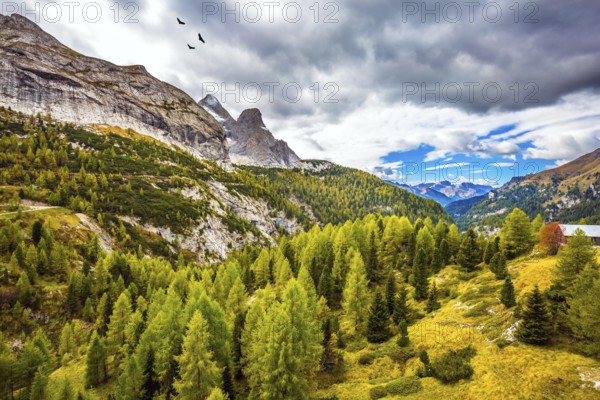 Autumn day. The shores of the glacial lake in the Dolomites. On the mountain slopes there is a