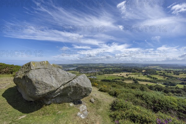 Large rock on a hill with sweeping views over a green landscape around Conwy and Conwy Castle on
