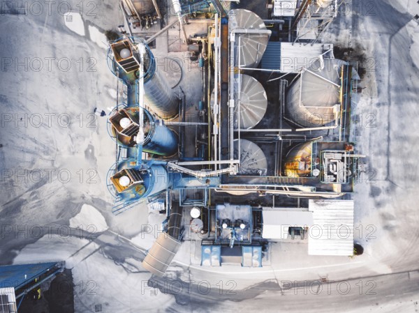 Aerial view of construction firm, asphalt base, whre gravel is being stored for the needs of road