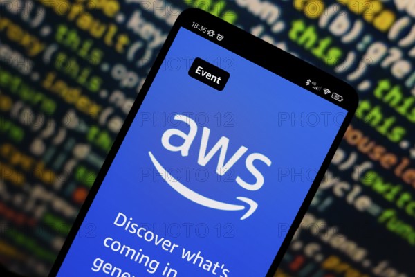 In this photo illustration, the Amazon Web Services (AWS) logo is displayed on the website on the