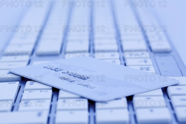 Close-up of a credit card for cashless payment and keyboard. Symbol photo for shopping on the