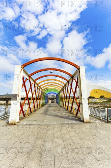 Magnificent light bridge over the river Aviles. The picturesque town of Avilas in Asturias. North