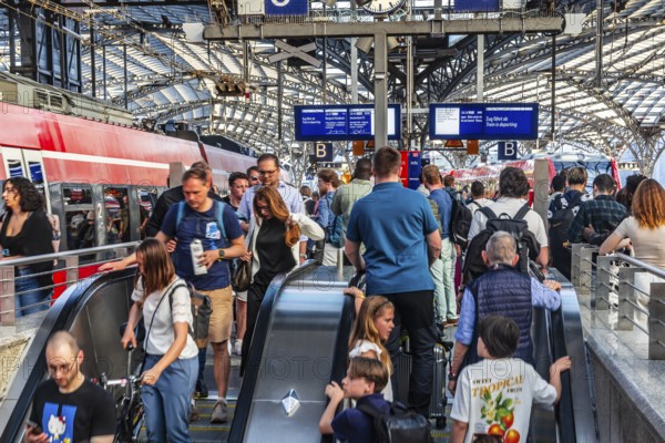 Cologne Central Station. Stairs to the platforms. Travellers waiting for their train on the