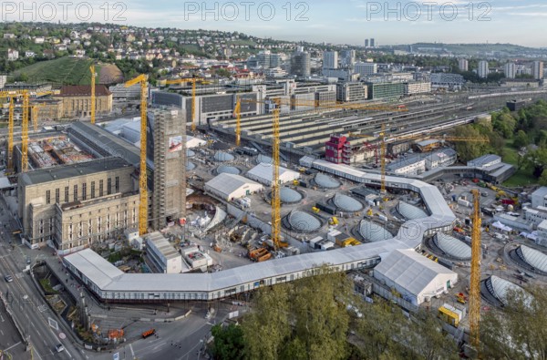 Stuttgart main station with Bonatzbau. Stuttgart 21 construction site with station tower and crane.