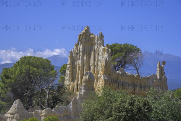 Sandstone cliff Les Orgues with Mount Canigou in the background, Ille-sur-Têt, Centre Ville