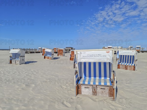 Preparing for the high season on the beach, setting up the beach chairs, North Sea, on the edge of