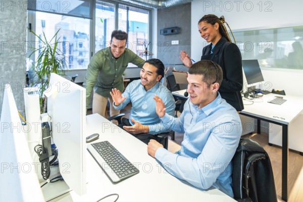 Business colleagues waving enthusiastically at the computer during an engaging video call in a