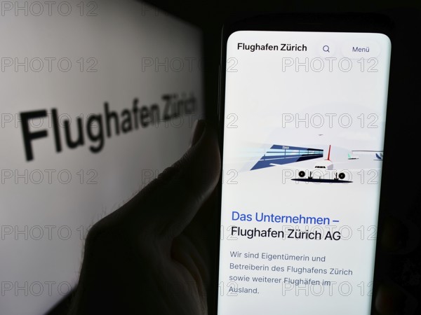 Stuttgart, Germany, 05-31-2024: Person holding smartphone with website of Swiss airport operator
