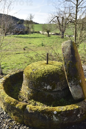 Old millstones in the national park community of Weiden near the Hunsrück-Hochwald National Park in