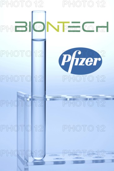 A single syringe, corona vaccine from Biontech and Pfizer, logo, test tubes, laboratory examination