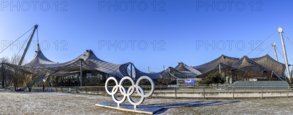 Panoramic photo of the sculpture of the Olympic rings and in the background the Olympic site with
