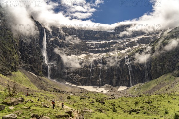 Hikers in the cloudy Cirque de Gavarnie basin, UNESCO World Heritage Site in the Pyrenees National