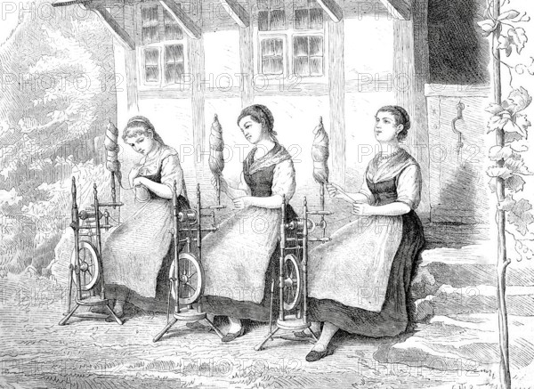 Three girls sitting in front of a house, with spinning wheel, spinning wool, around 1870,