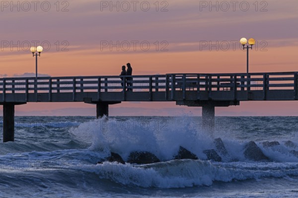 Sunset, pier, people, silhouettes, waves, swell, spray, street lamps, Wustrow, Fischland,