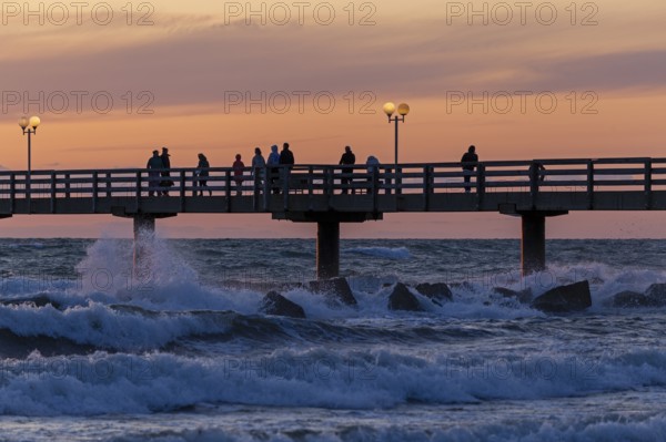 Sunset, pier, people, silhouettes, waves, swell, spray, street lamps, Wustrow, Fischland,