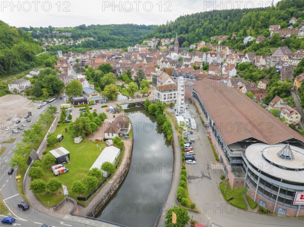 A river runs through the cityscape with a Ferris wheel and environmentally friendly surroundings,