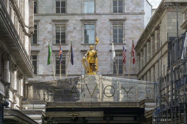 Count Peter of Savoy golden figure above entrance to The Savoy hotel, Strand, central London,
