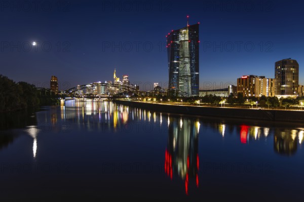 The European Central Bank (ECB) and the Frankfurt banking skyline are reflected in the calm waters