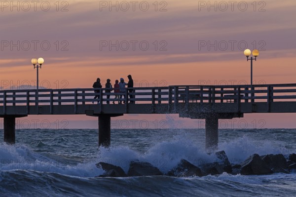 Sunset, pier, people, silhouettes, waves, swell, spray, street lamps, Wustrow, Fischland,