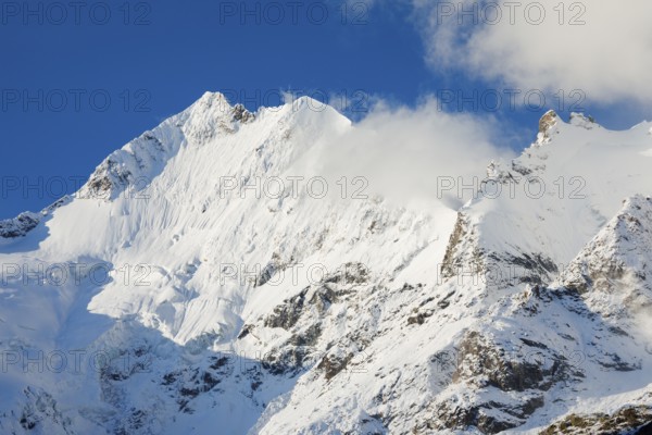 Freshly snow-covered summit of Piz Bernina and Biancograt, Engadin in the canton of Graubünden,