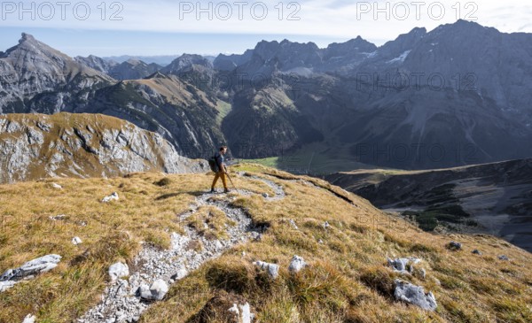 Mountain panorama with picturesque mountain landscape, mountaineers descending from the Gamsjoch,