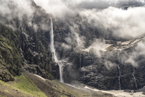 Waterfall in the cloudy Cirque de Gavarnie basin, UNESCO World Heritage Site in the Pyrenees