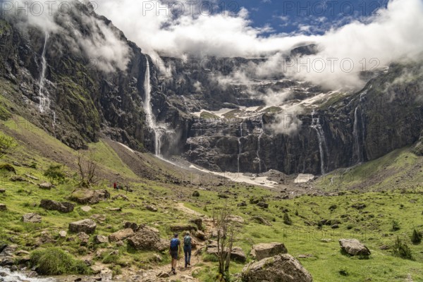 Hikers in the cloudy Cirque de Gavarnie basin, UNESCO World Heritage Site in the Pyrenees National