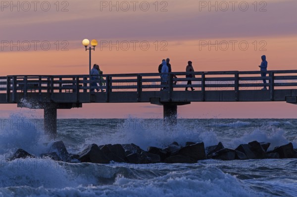 Sunset, pier, people, silhouettes, waves, swell, spray, street lamps, Wustrow, Fischland,