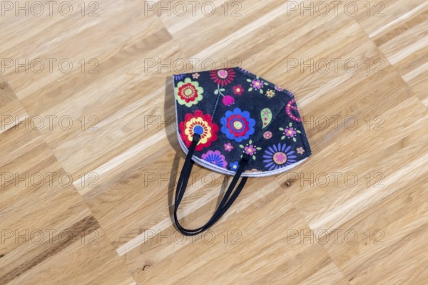 Protective mask during the pandemic. Colourful corona mask lying on the floor. Stuttgart,