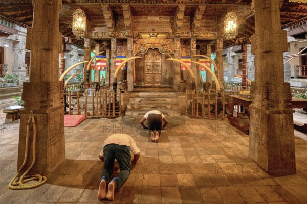 Pilgrims praying in front of the Holy Shrine, Temple of the sacred Tooth Relic or Sri Dalada