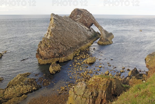 Impressive coastal view of a rock formation reaching far into the sea, Bow Fiddle Rock,