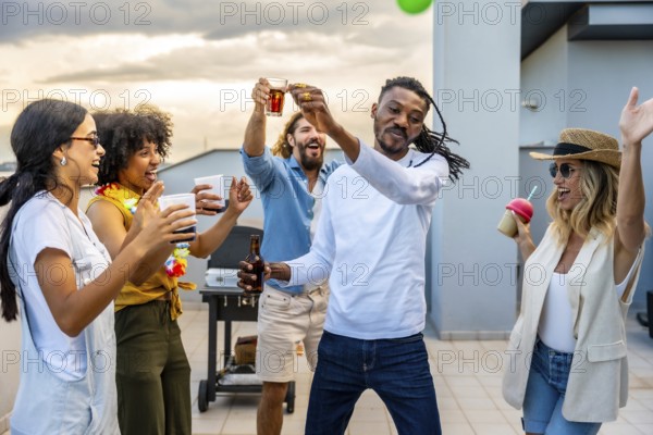 Cheerful friends toasting and dancing together at a vibrant rooftop party, enjoying drinks and