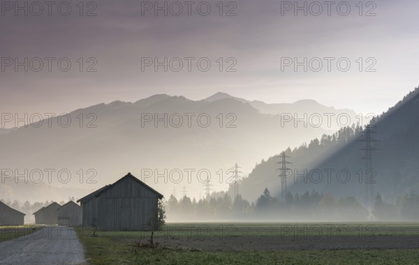 View of the Praettigau Valley near Klosters in Switzerland on an early morning with farm fields and